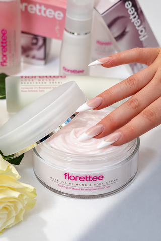 Florettee Rose Oil BB Hand & Body Cream with soft pink cream and Florettee skincare products in the background.